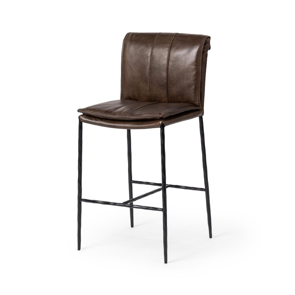 Slim-frame dark brown leather counter stool in a three-quarter front view, showing the stitched seat and slender iron legs
