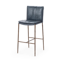 Slim-frame blue leather bar stool in a three-quarter front view, showing the stitched seat and brown iron legs