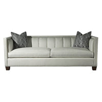 Front view of plush channeled sofa with pillows.