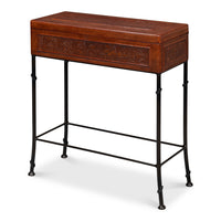 Botanical embossed leather storage box with a hinged lid on a faux bamboo iron stand