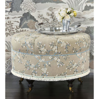 Poof with tray and flowers, elegant room setting.