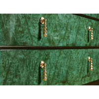 Close-up of emerald dresser handles and texture.