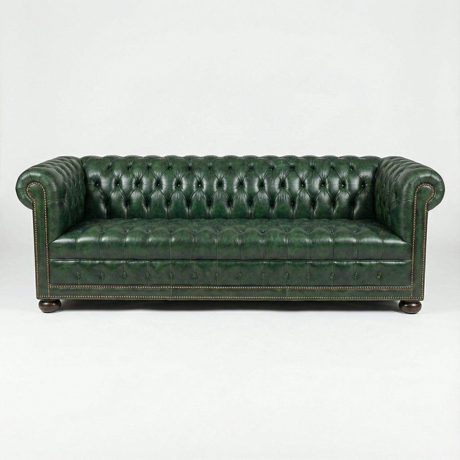 Front view, green leather Chesterfield sofa, classic design.