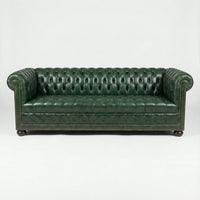 Front view, green leather Chesterfield sofa, classic design.