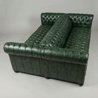 Green leather Chesterfield sofa, top view, button-tufted detail.