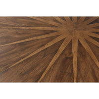 Starburst pattern detail on wooden dining table top.