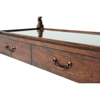 Close-up of antique serving table drawers with handles.