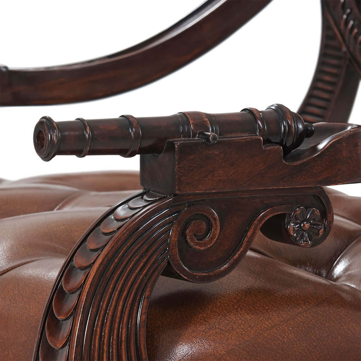 Close-up of cannon design on armchair armrest.