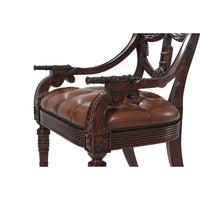 Armchair armrest highlighting cannon-shaped design.