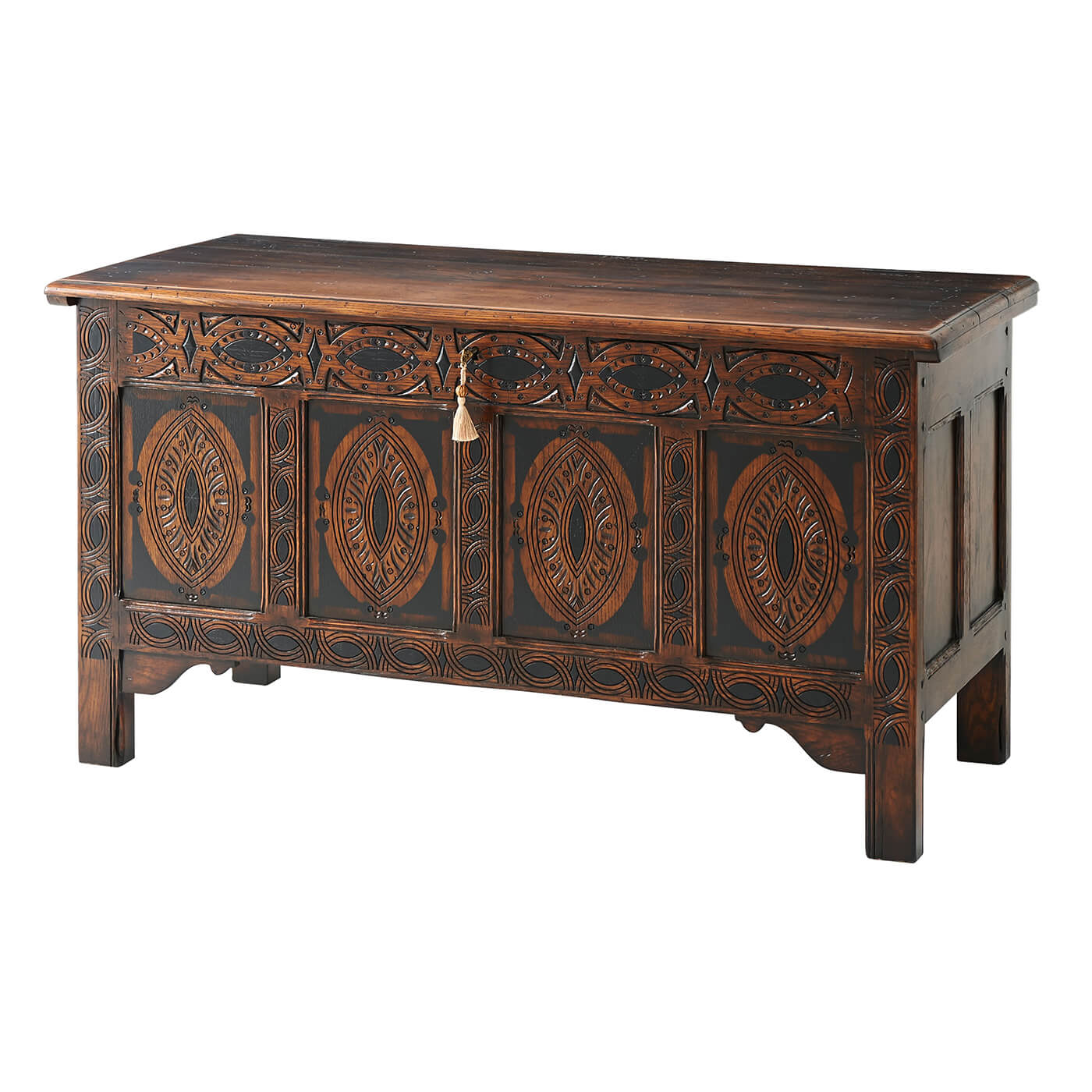 Closed English blanket chest with intricate carvings.