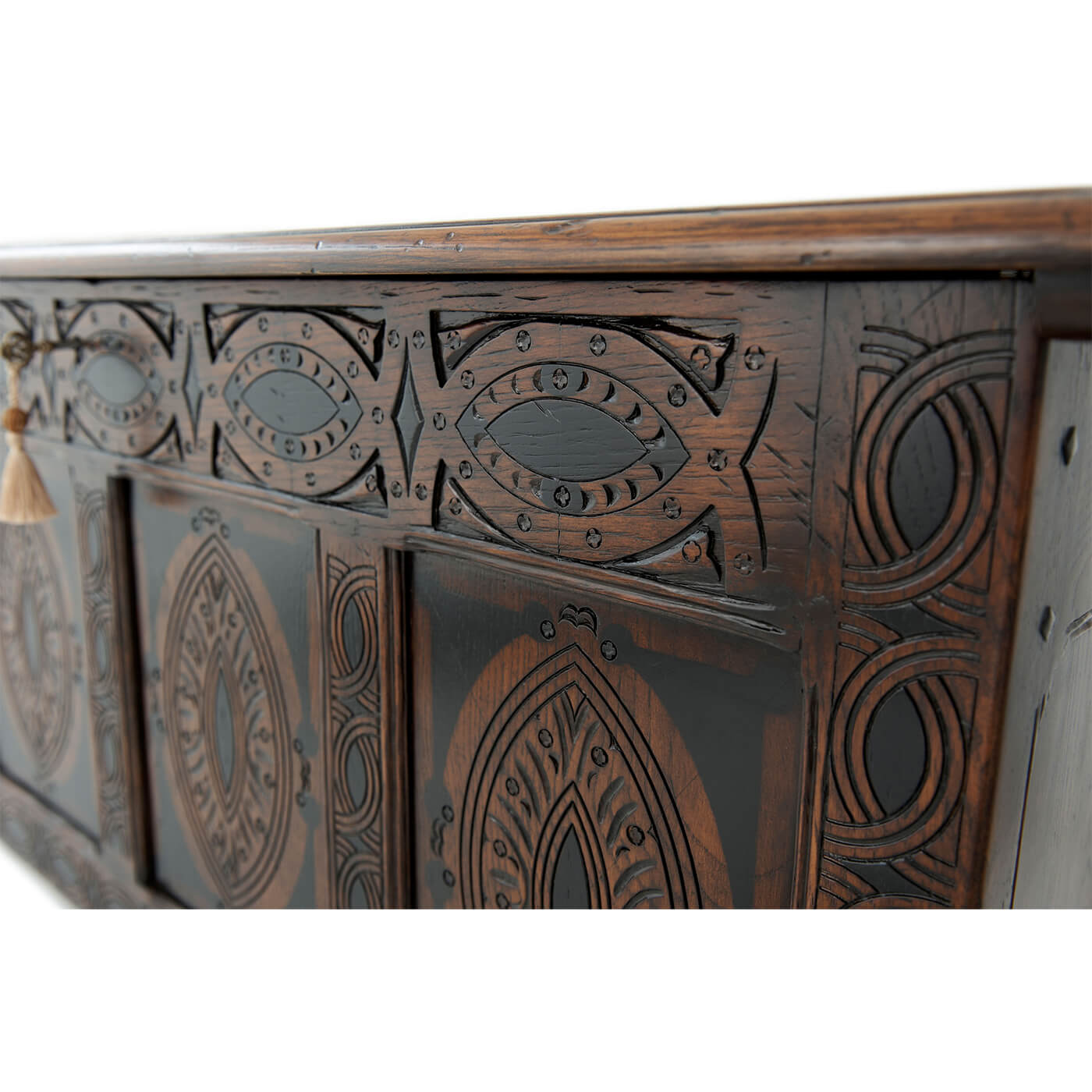 Detailed view of English blanket chest ornate designs.