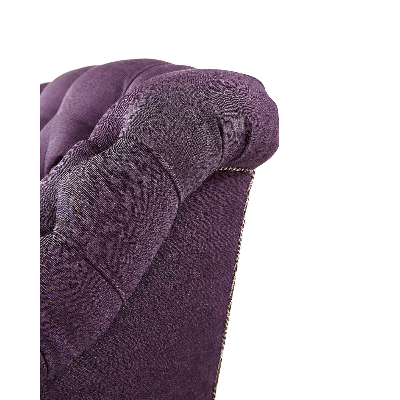 Close-up of tufted detail on purple club chair.