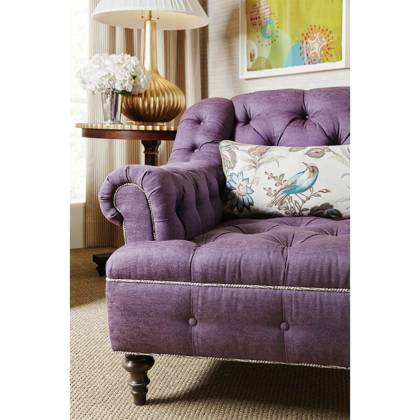 Purple club chair in room setting with cushion.