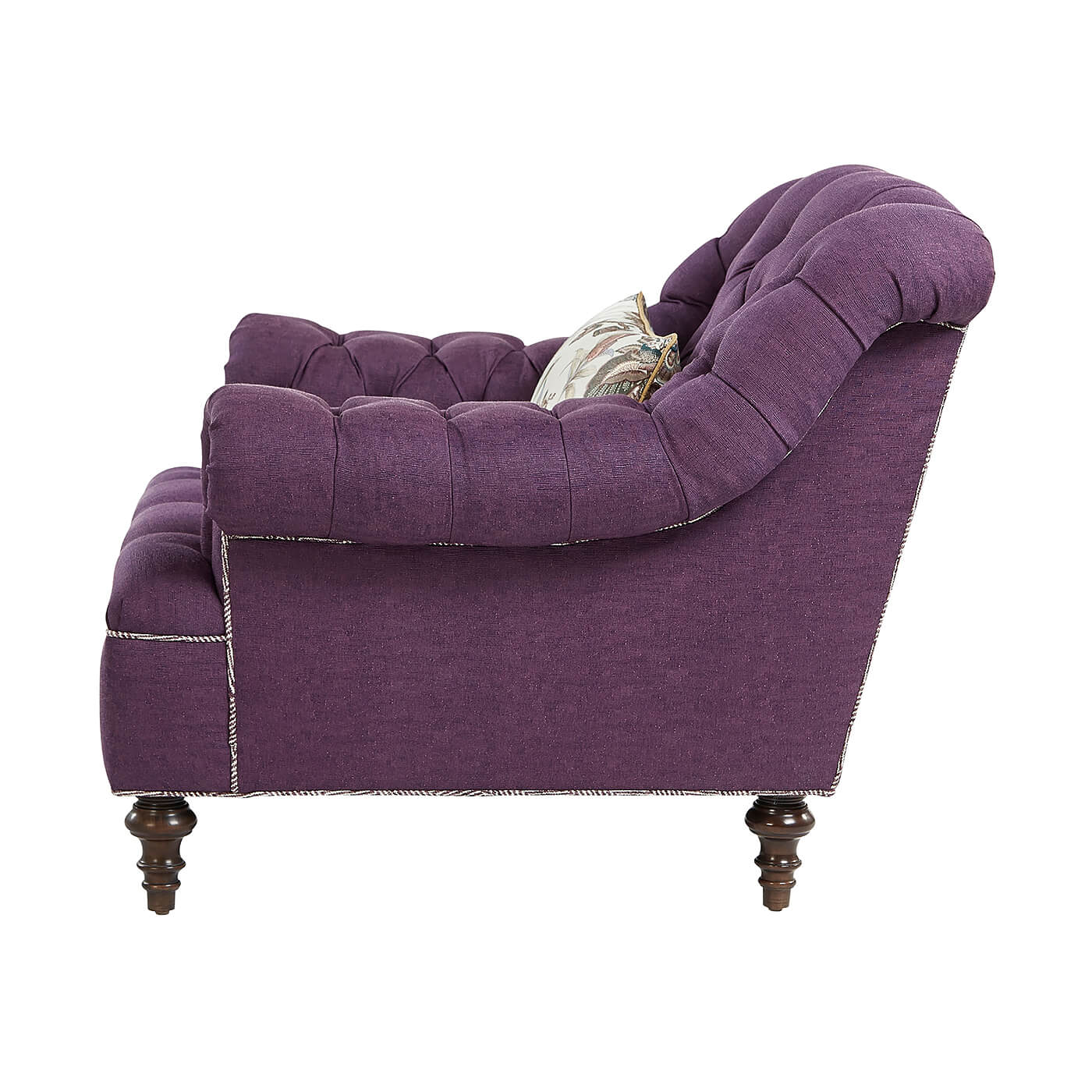 Side view of purple tufted club chair detailing.
