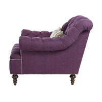 Side view of purple tufted club chair detailing.