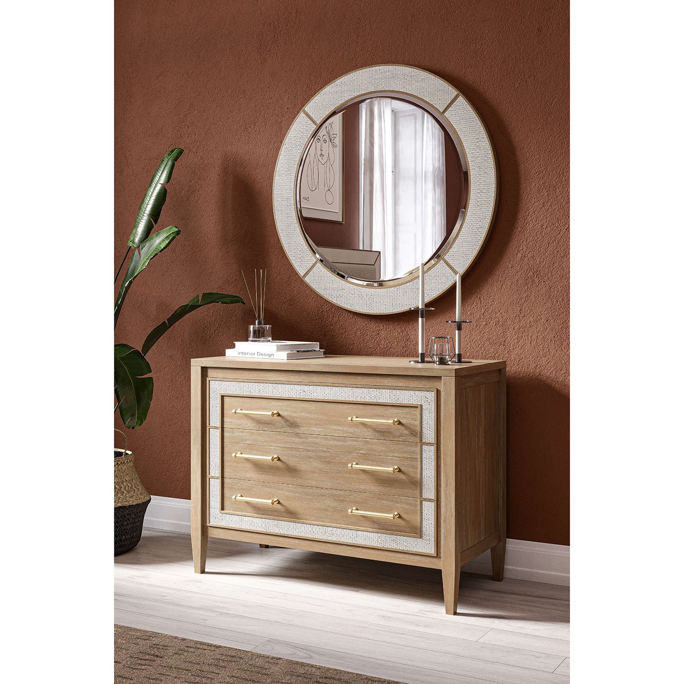 Modern chest of drawers under round mirror, decor styled.