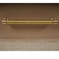 Close-up of chest of drawers brass handle design.
