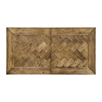 Top view of wooden dining table with herringbone pattern.