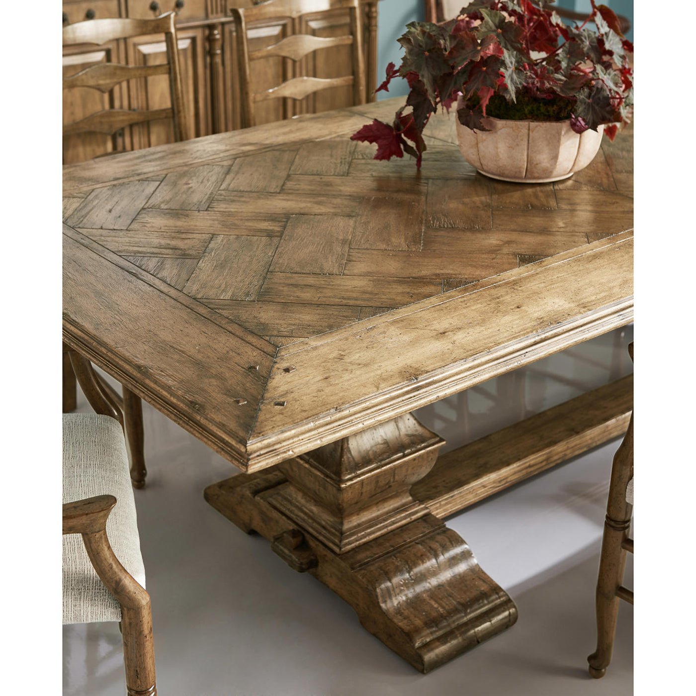 Close-up of table corner, showing herringbone wood pattern.