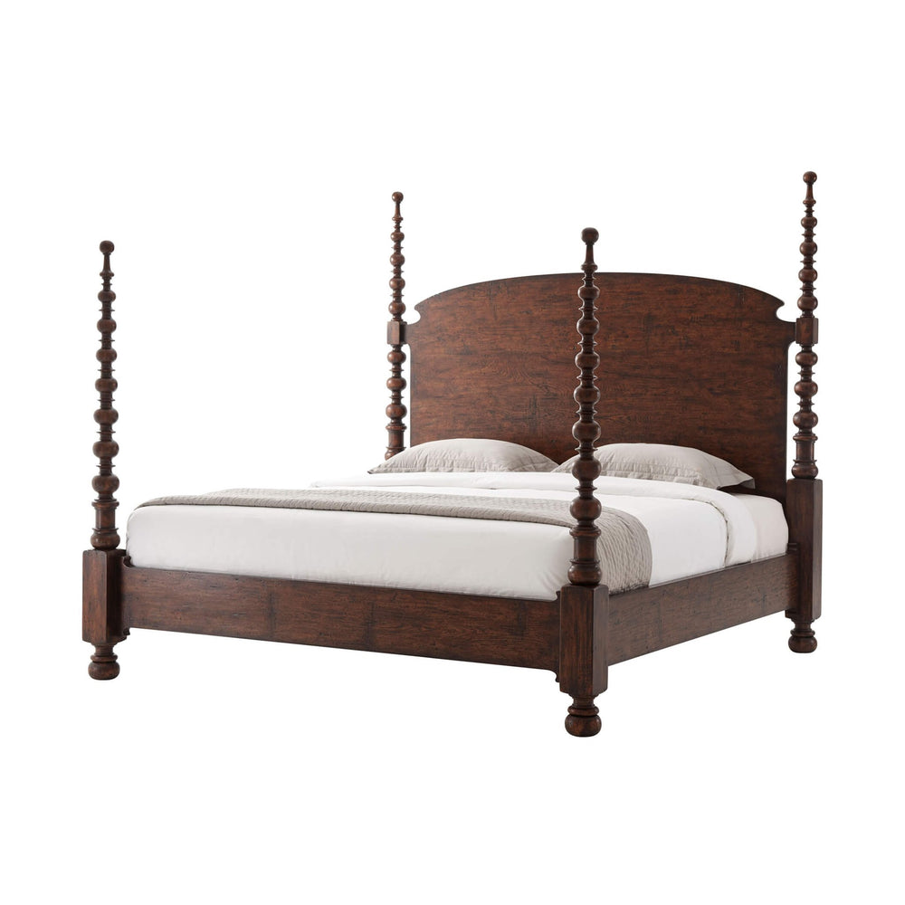 Dark wood four-poster king bed with white bedding.