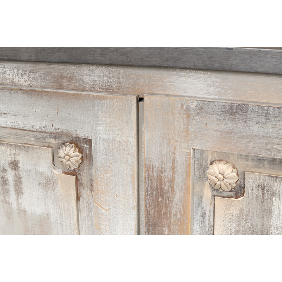 Detailed wood paneling with floral carvings close-up.