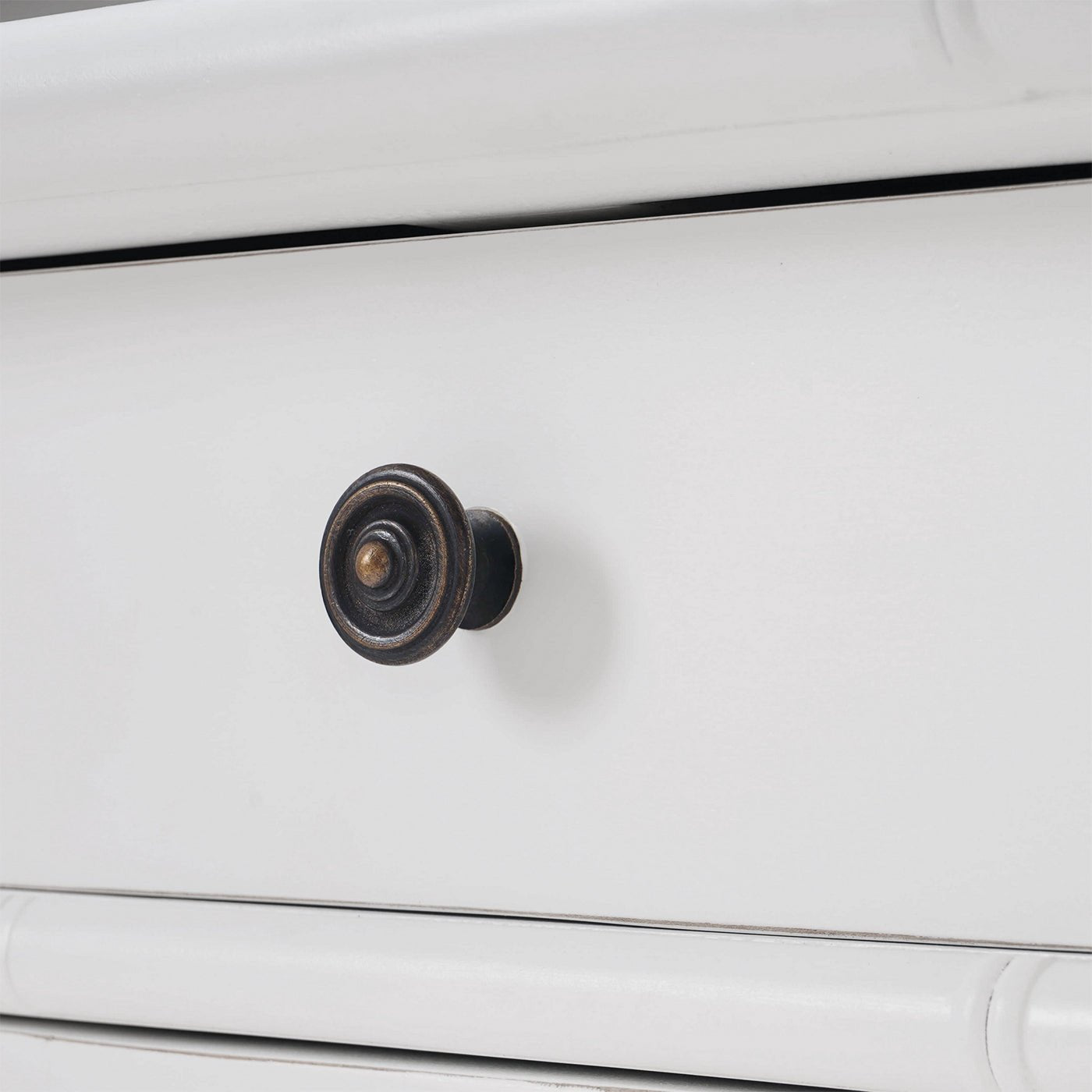 White end table close-up of drawer knob design.