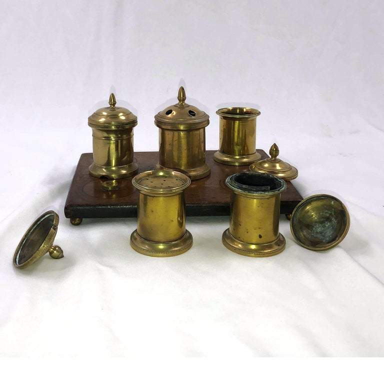 Disassembled English desk set inkwell with open lids.