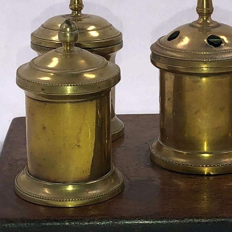 Close-up of brass inkwells from English desk set.
