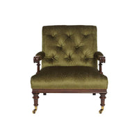 Front view of green English easy chair, tufted cushion, casters.