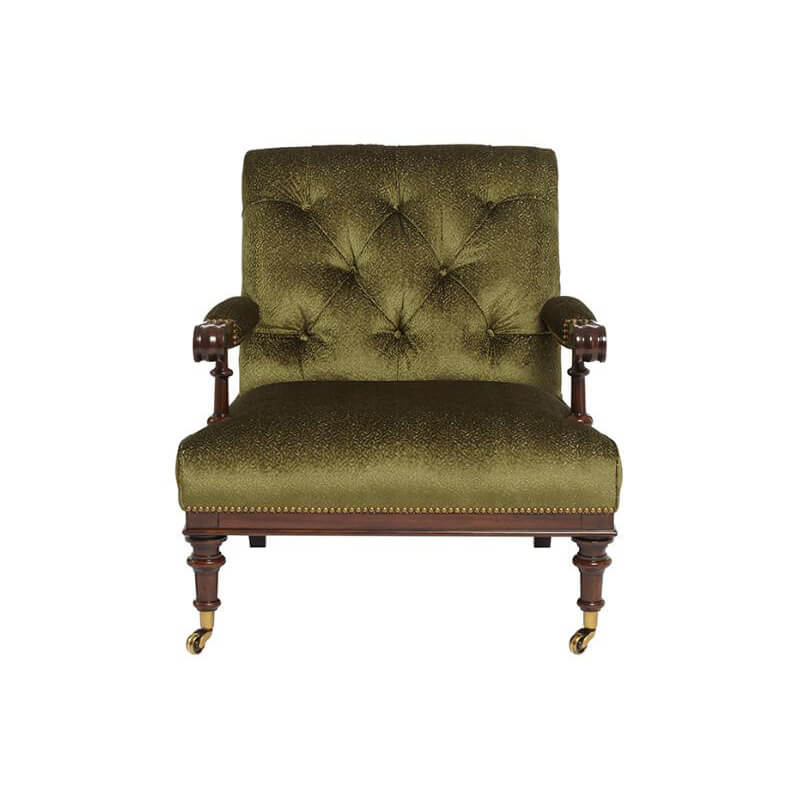 Front view of green English easy chair, tufted cushion, casters.