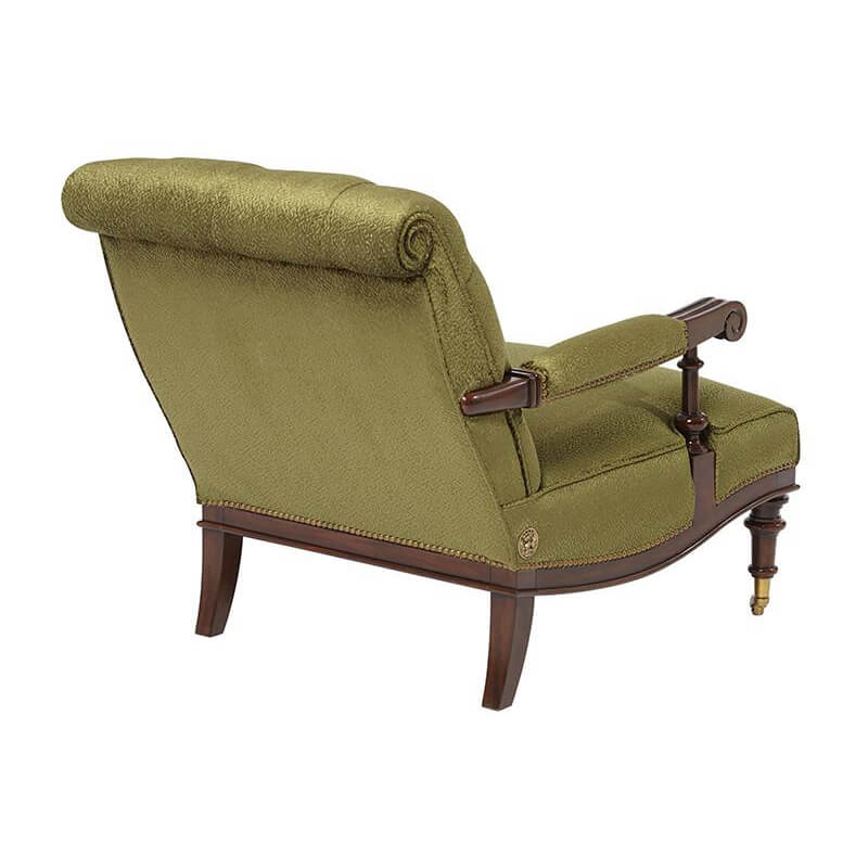 Green English easy chair, back view, rolled top, wooden frame.