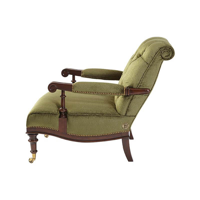 Side profile of green English easy chair, wooden arms.
