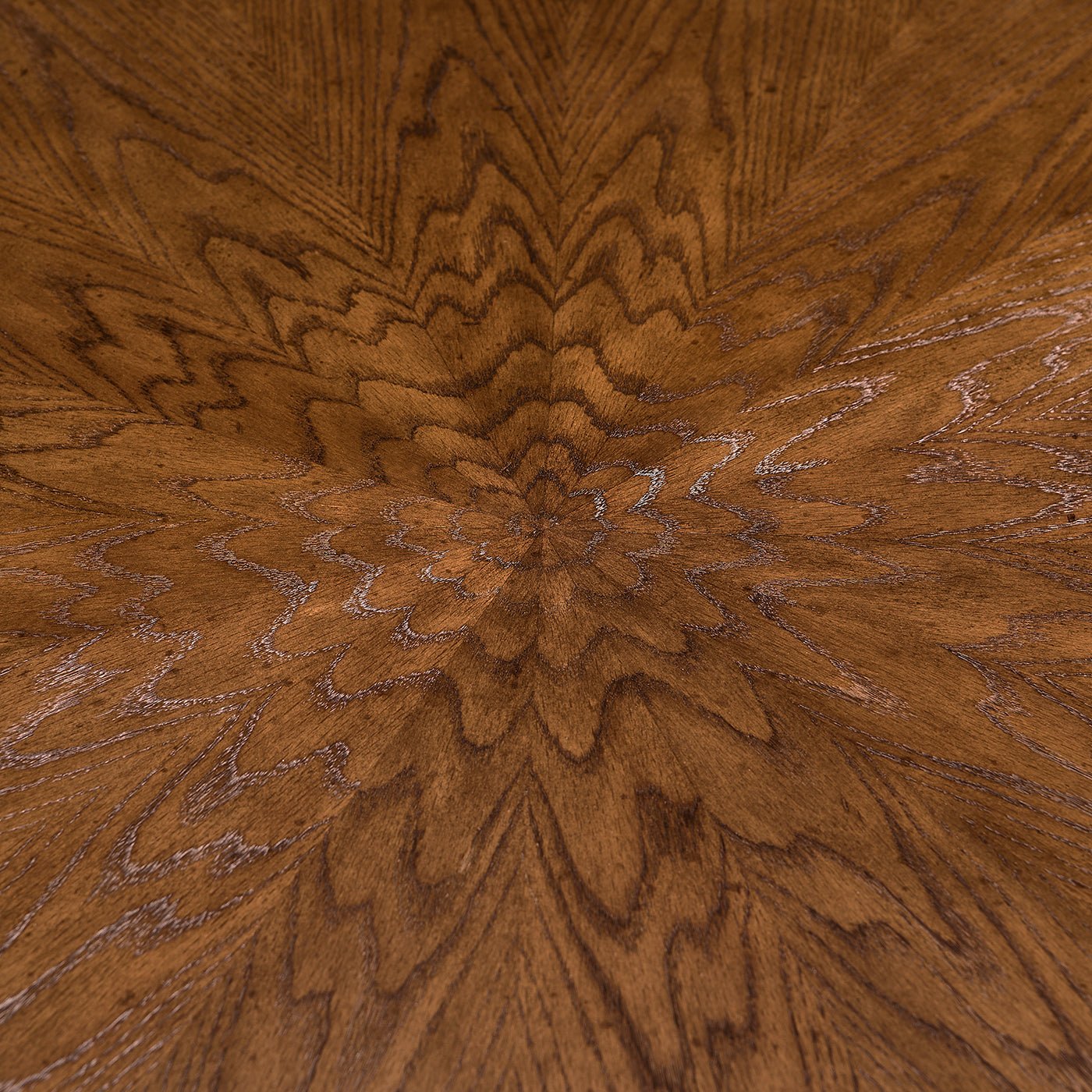 Detailed wood grain pattern on round oak dining table.