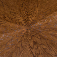 Detailed wood grain pattern on round oak dining table.
