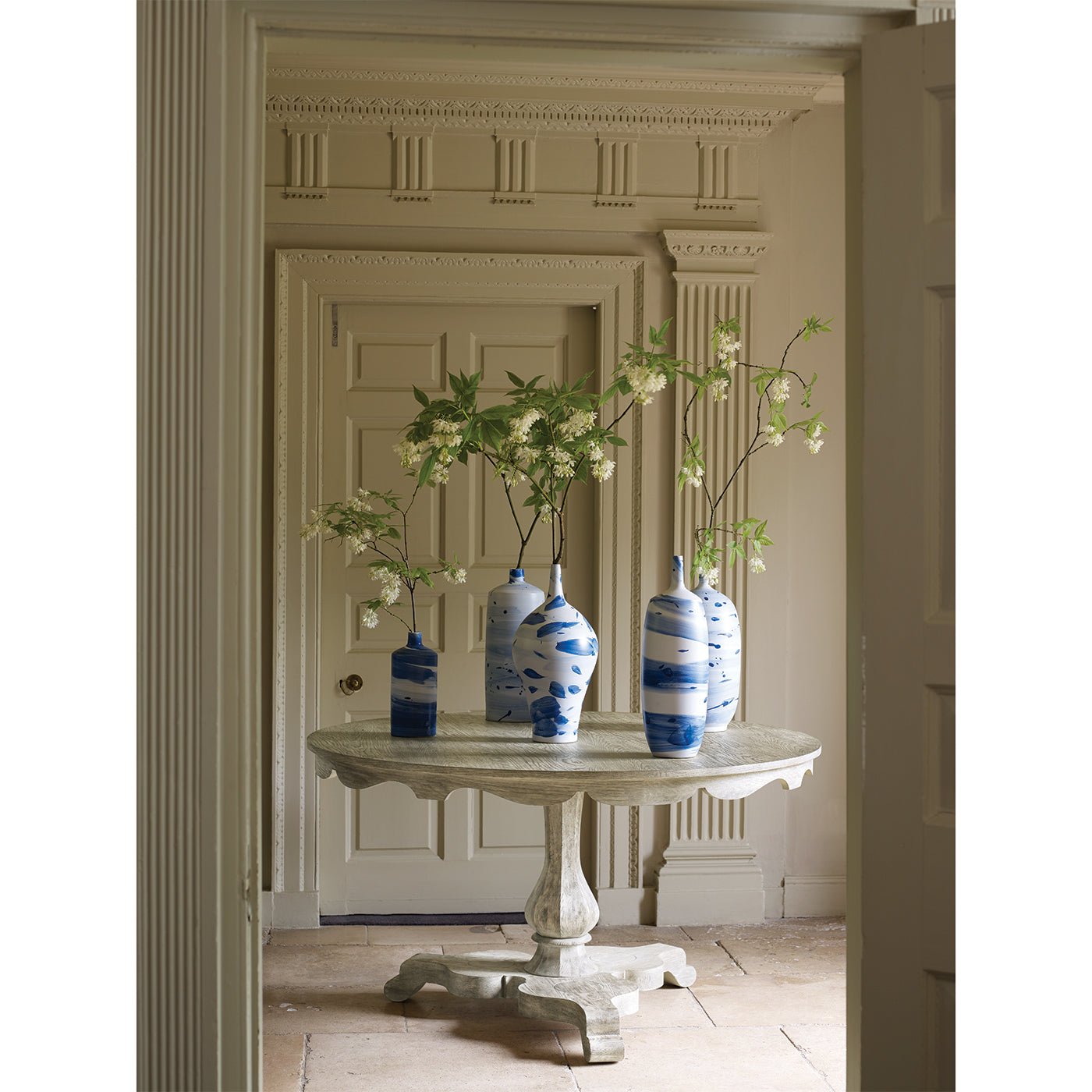 Table with blue vases, elegant interior setting.