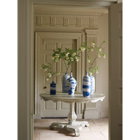 Table with blue vases, elegant interior setting.