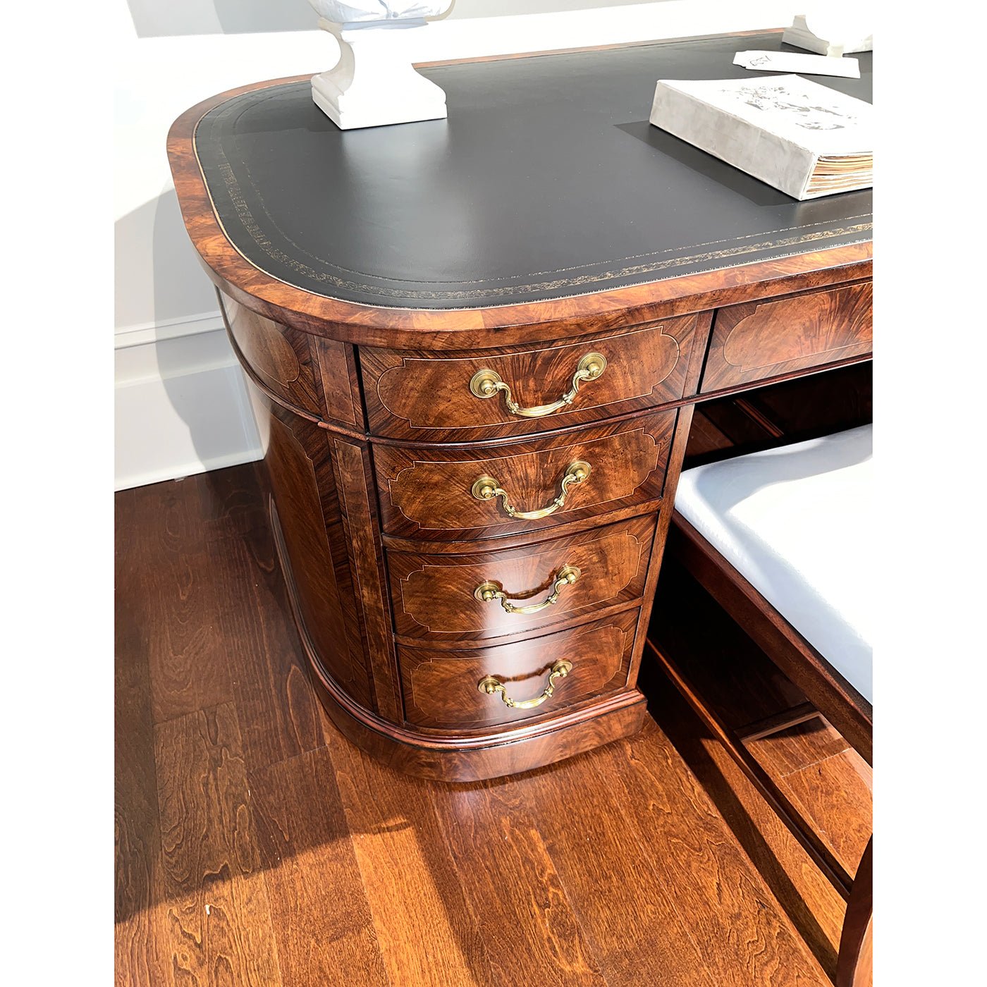 English leather top desk, close-up drawer handles and wood detail.