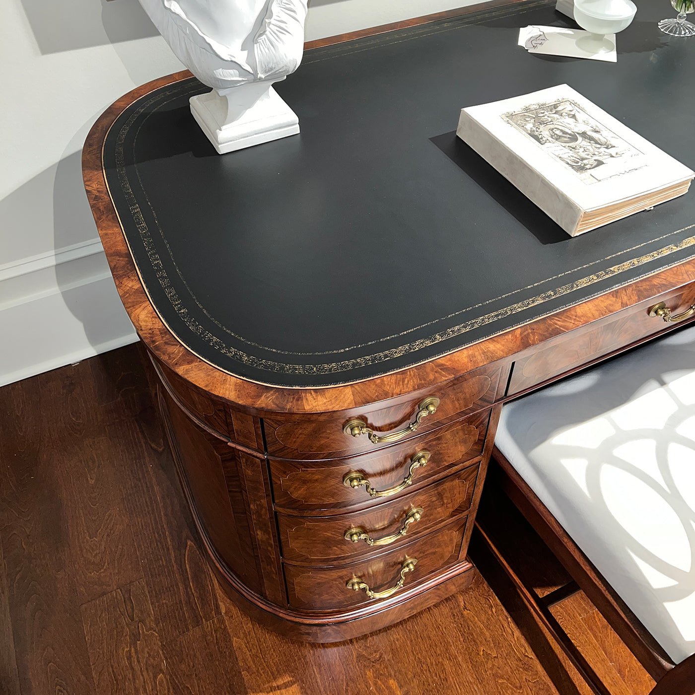English leather top desk, top corner view, decorative detailing.