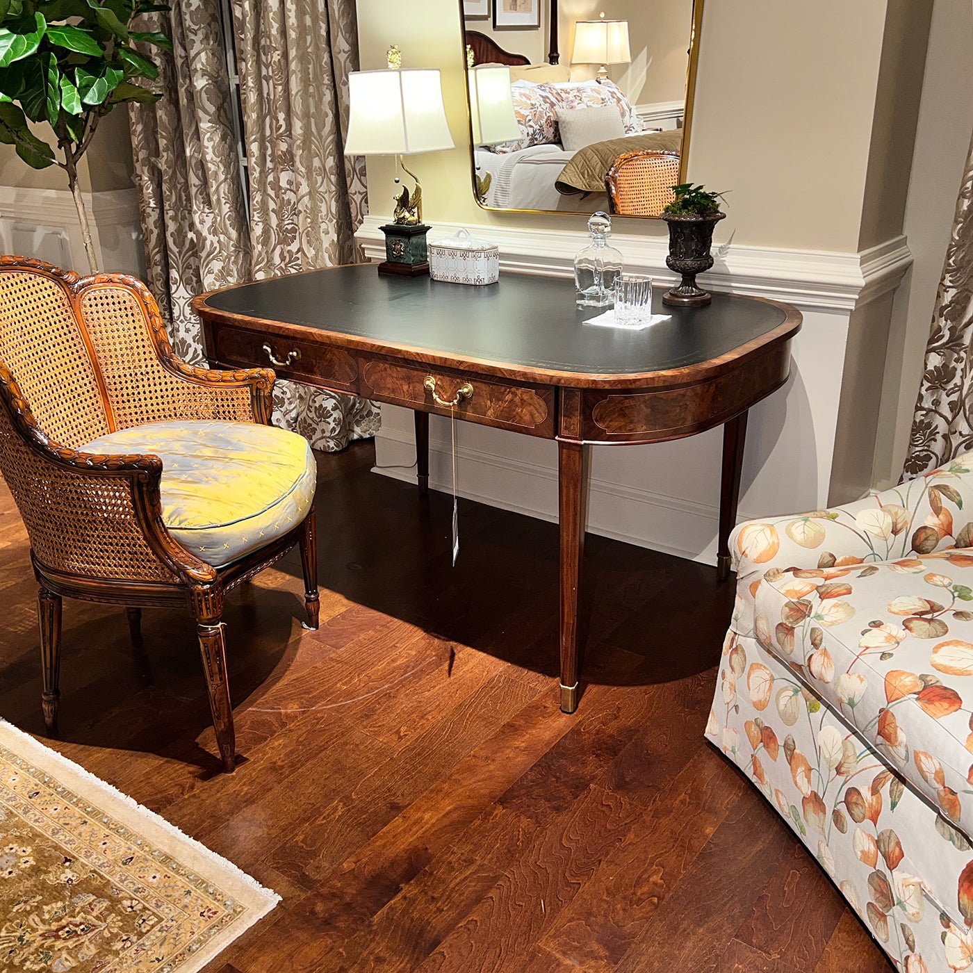 Writing table in room setting with different chairs and sofa.