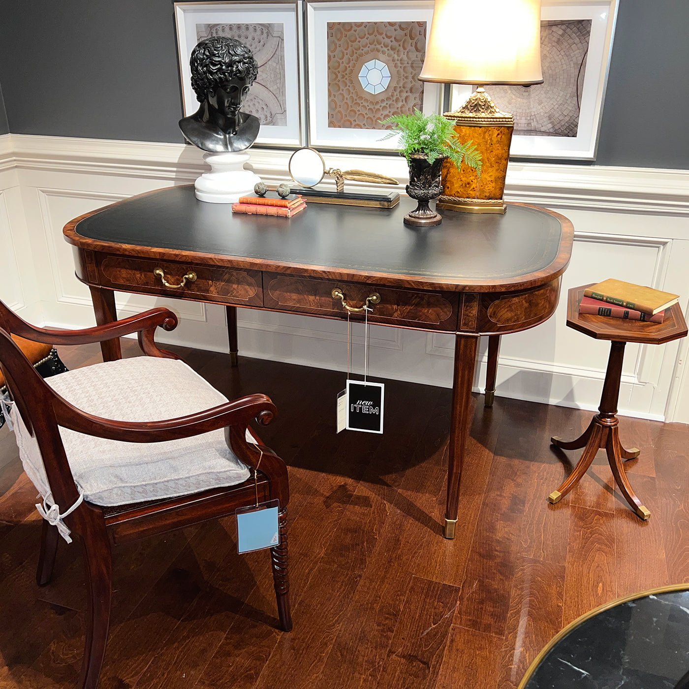 Writing table styled with chair and decor pieces in room.
