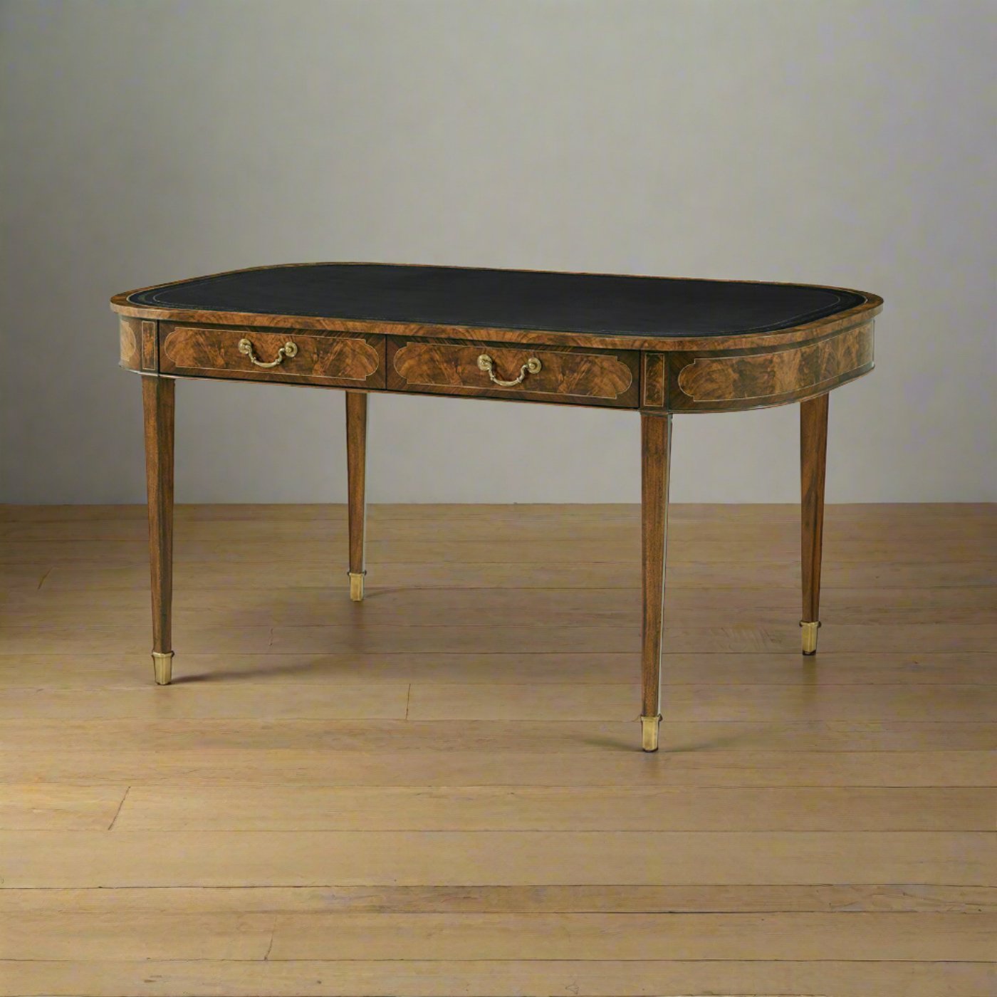 Writing table with leather top, positioned on wooden floor.