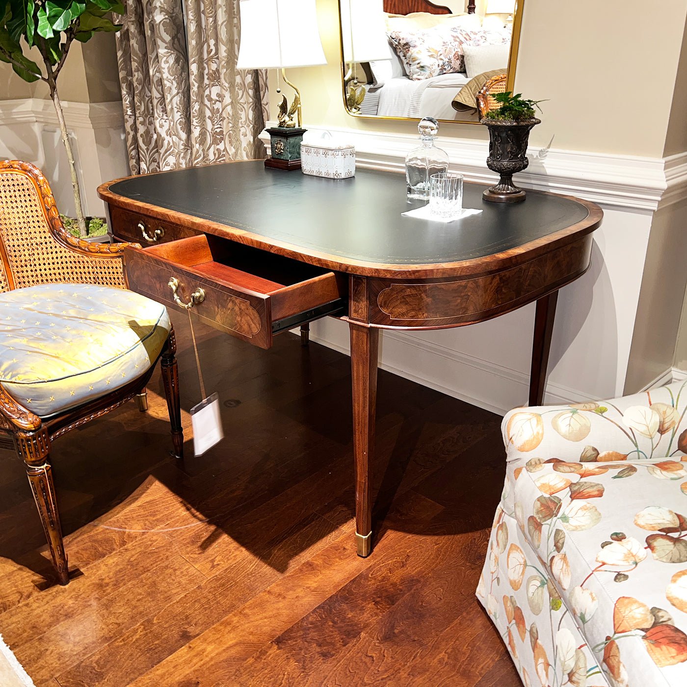 Writing table with open drawer, room setting.