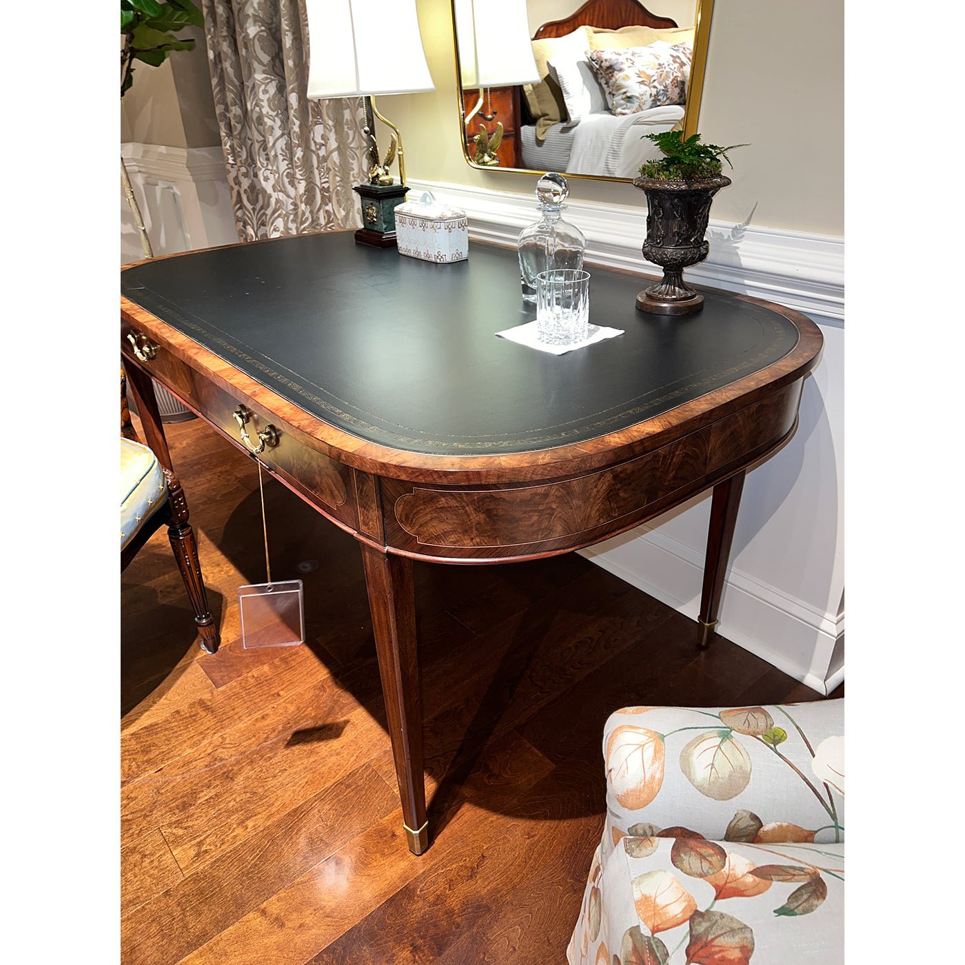 Close-up of writing table corner, decorative items, room setting.