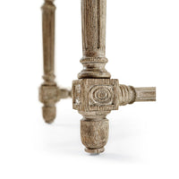 Detailed leg of console table with intricate carvings.