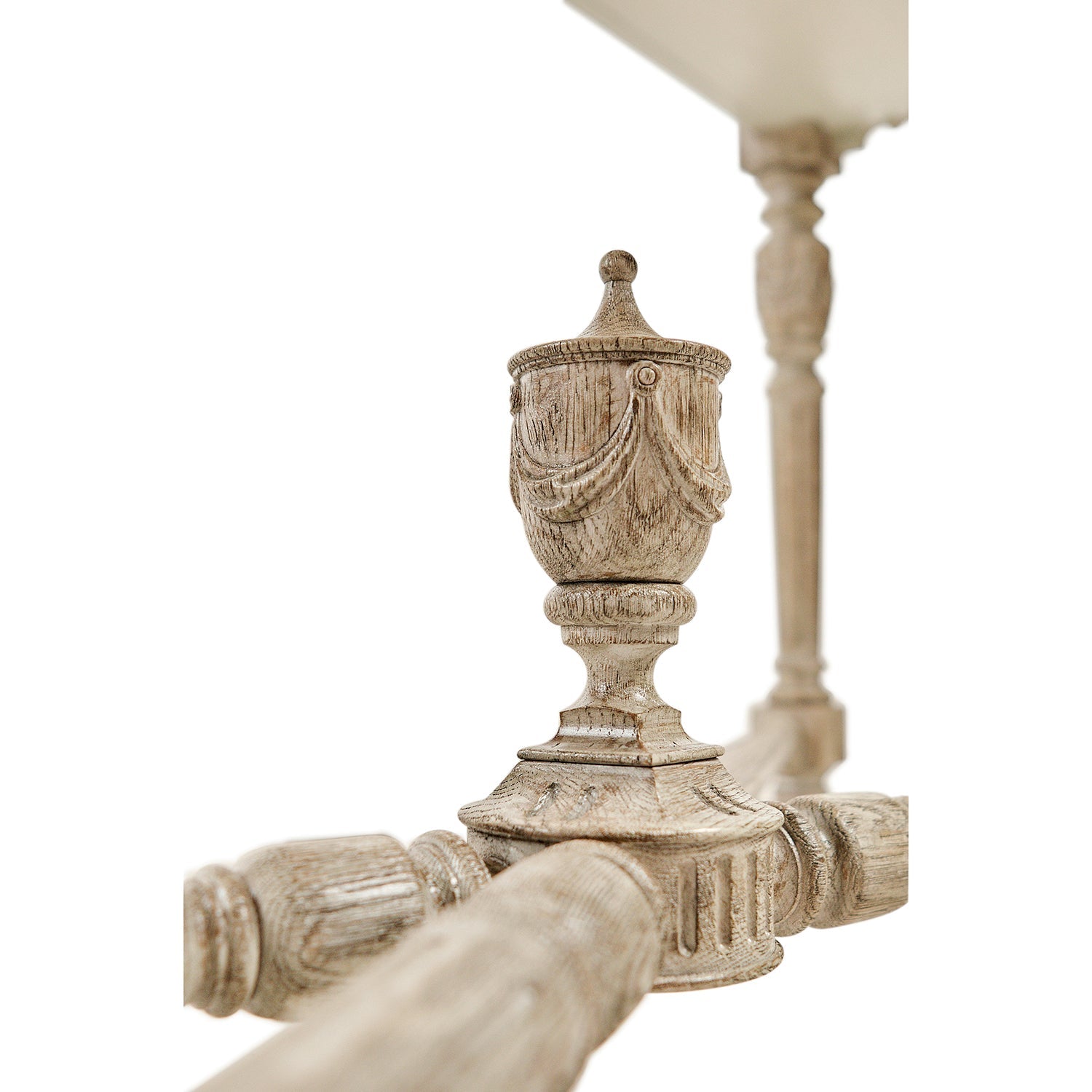 Center decor carving on console table crossbars.