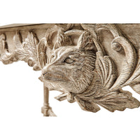 Close-up of animal carving on console table.