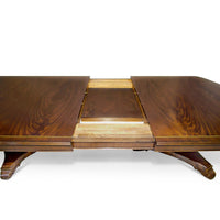 Dining table with extending mechanism and leaf detail.