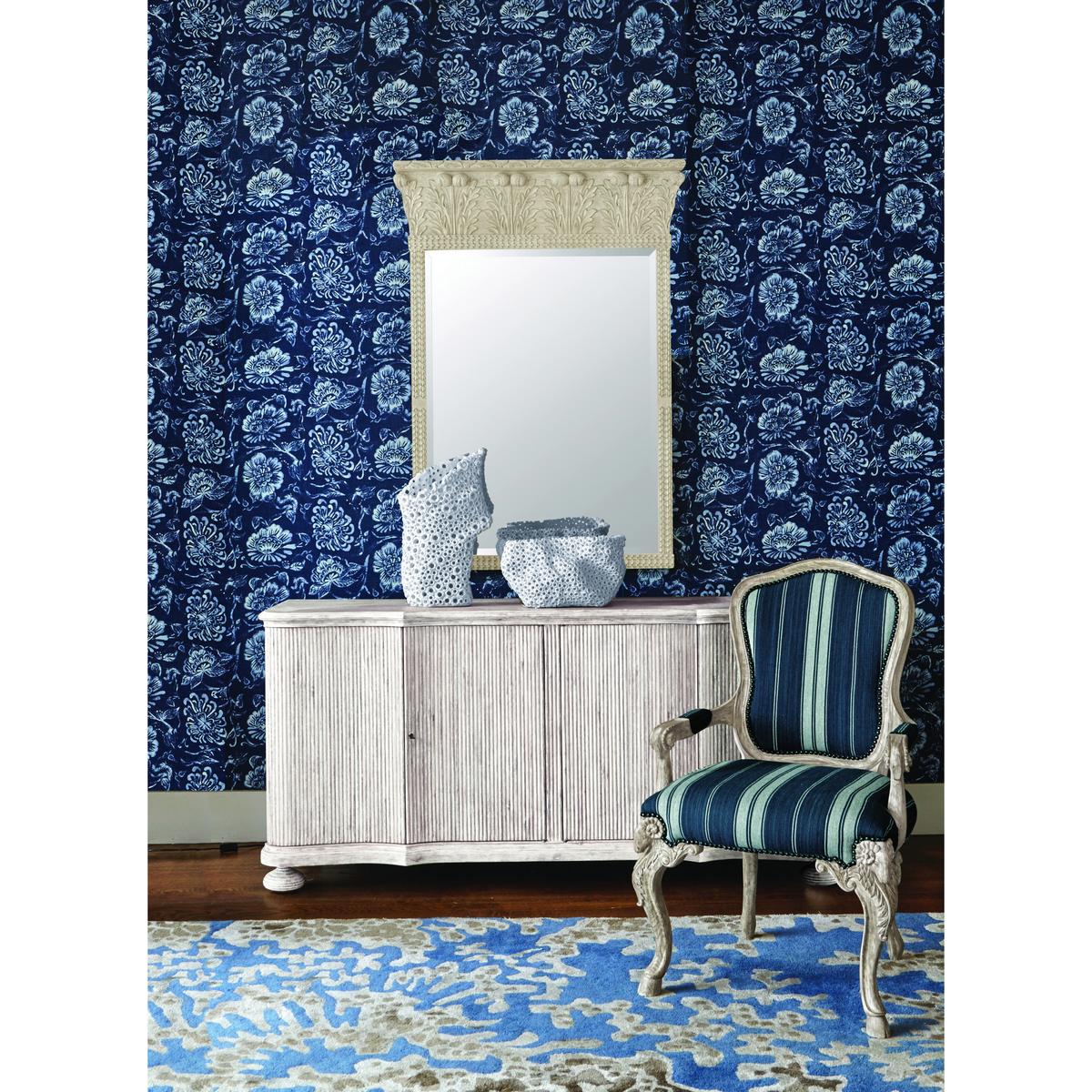 English Rococo armchair in room setting with floral wallpaper.