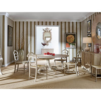 Elegant dining room setup with round oak table, striped walls.