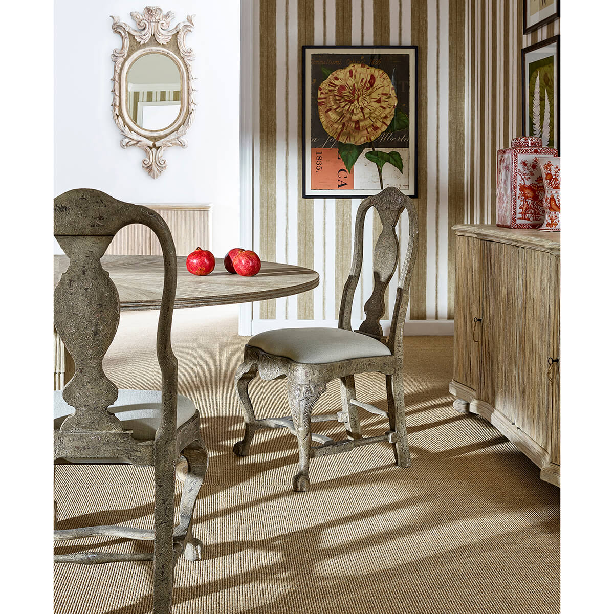 Dining table with chairs, mirrors, and decor setting.